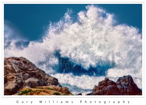 Photograph of a wave crashing against rocks at Pacific Grove, California