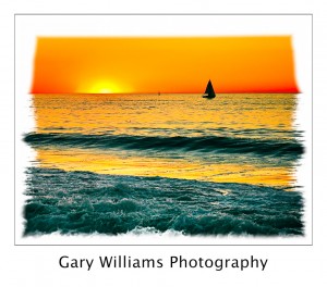 Photograph of a sailboat at sunset off the central California coast near Moss Landing, California