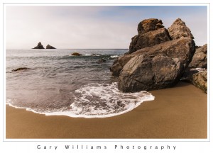 Photograph of waves, beach, and sea stacks at Lone Ranch beach in Oregon
